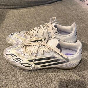 adidas F50 Club FxG Soccer Cleats
White gold, black, and purple . Used.